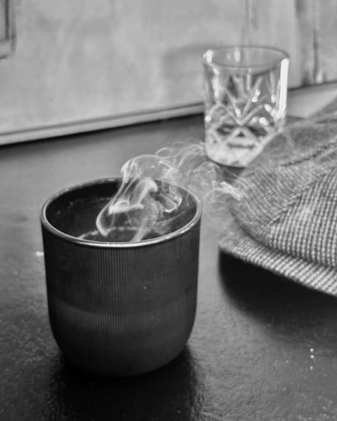 the gentlemen candle in a black ribberd jar